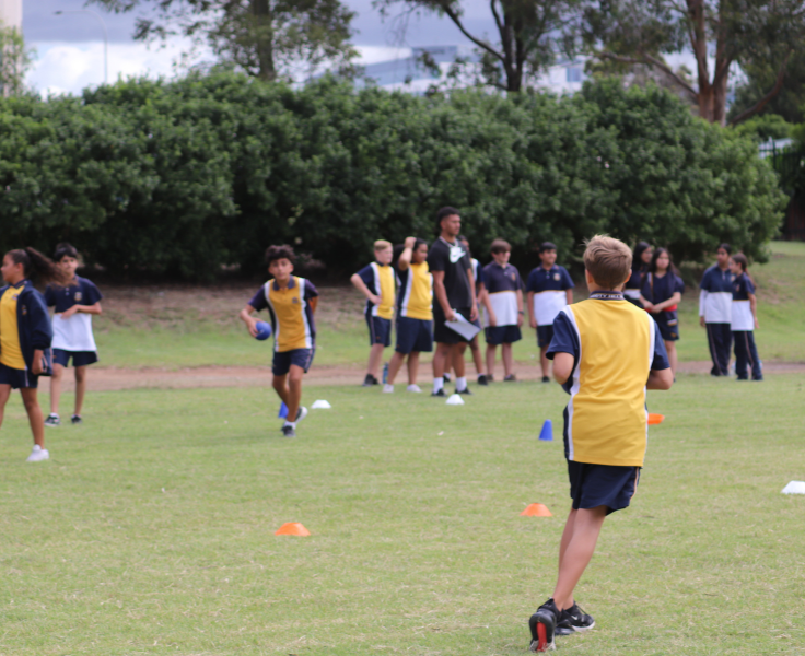 Students running on a green oval.